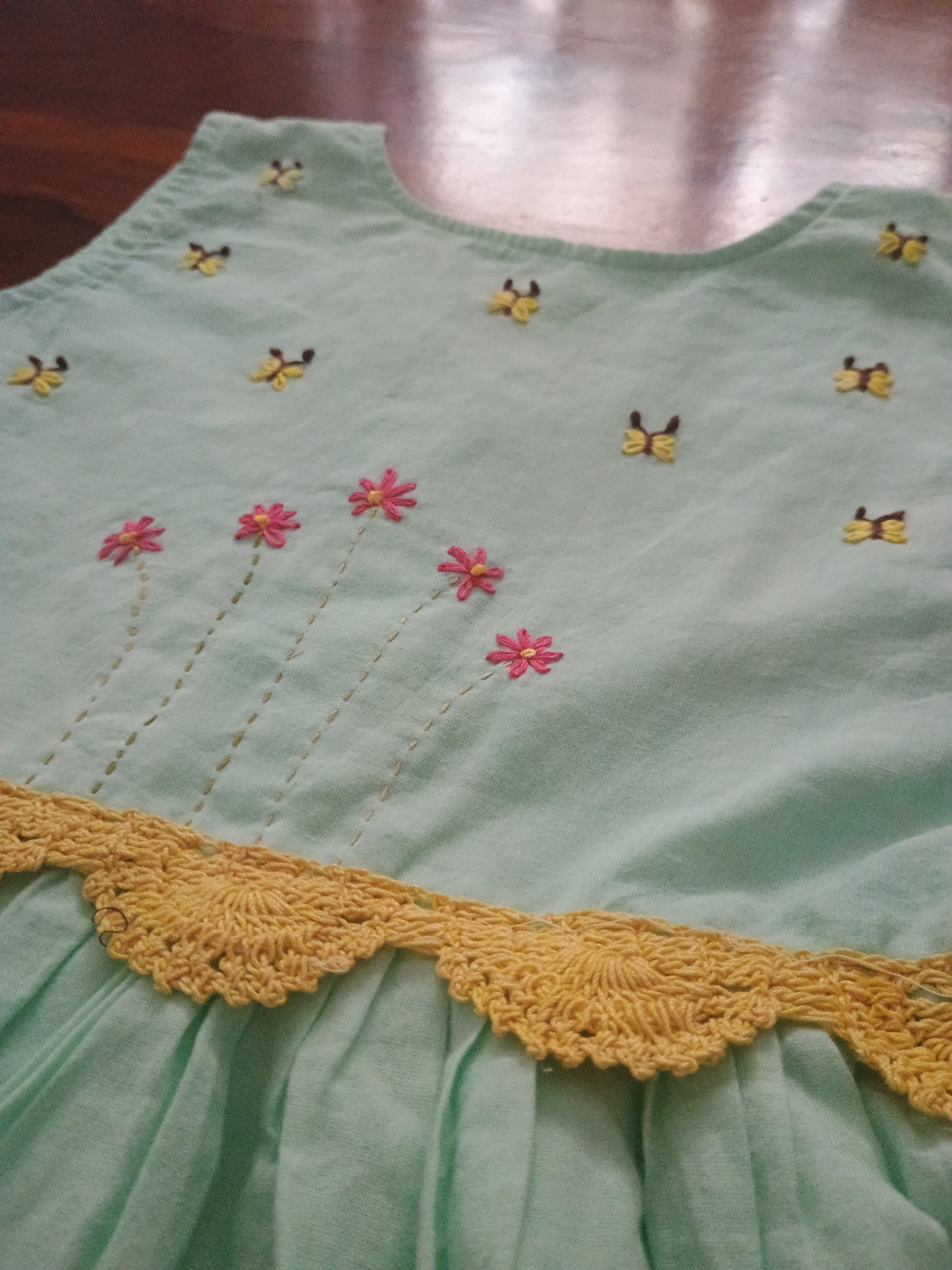 Sleeveless mul cotton in pista green with hand embroidery.